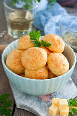 Baked cheese balls in a bowl on a wooden table, selective focus