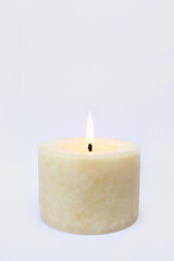 Fototapeta na wymiar aromatic scented ivory lighting round pillar candle is isolated on white background
