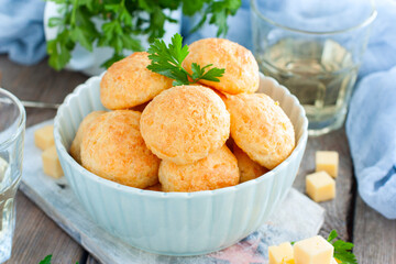 Baked cheese balls in a bowl on a wooden table, selective focus