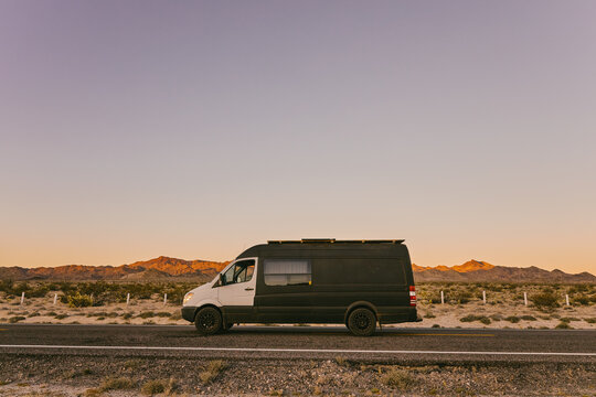 Camper van on highway during sunset in desert of Baja, Mexico.