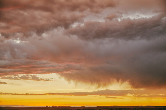 Storm clouds during sunset over desert landscape in Moab, Utah.