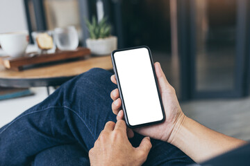 cell phone mockup blank white screen.woman hand holding texting using mobile on desk at coffee shop.background empty space for advertise.work people contact marketing business,technology