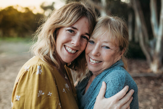 Close up portrait of adult mother and senior mother smiling outside
