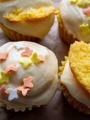 orange and yellow cupcakes with buttercream frosting