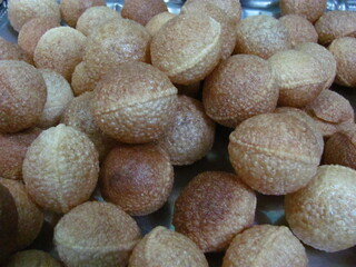 Panipuri is a common street snack from India. It's a round, hollow puri filled with a mixture of flavoured water and other chat items. It is also called Golgappa
