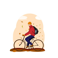 a young man rides a bicycle under a leaf fall. warm clothes in the fall