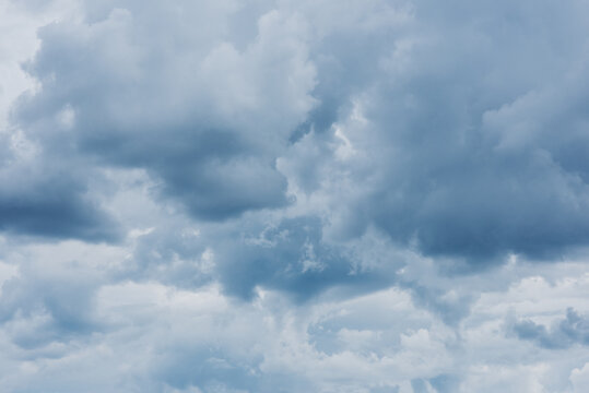 moody fluffy blue cloudscape  in summer