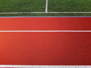 Red treadmill with white lines in a sports stadium. Red running tracks in the stadium. Empty sport stadium. 