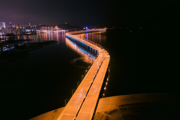 Aerial photo of the lights of the cross sea bridge at night was taken in Dalian, Liaoning Province,...
