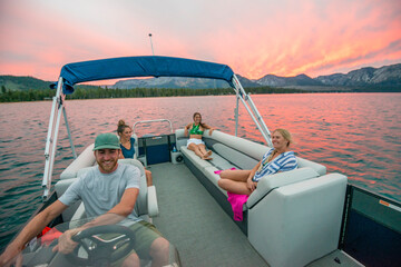 A group of friends boating on Lake Tahoe at sunset, CA