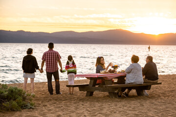 A family enjoys a beach picnic on the shoreline of Lake Tahoe, NV