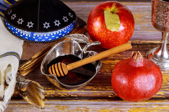 Shofar and tallit with glass honey jar and fresh ripe apples. Jewesh new year symbols. Rosh hashanah