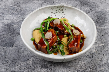 pork in sauce with potatoes,onions, green peas