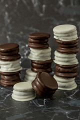 Homemade chocolate alfajores, typical of Argentina, marble background with copy space