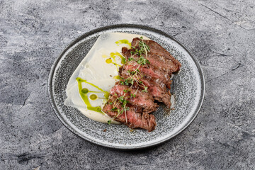 Grilled beef steak with herbs and sauce.