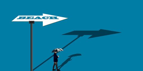 Shot of a man with a umbrella walking towards the beach with a arrow sign up ahead  pointing the beach direction.