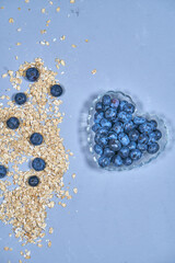 Blueberries and bunting for the background. Groats and berries on the splash screen. A delicious snack. Blueberries and muesli. Granule. High quality photo