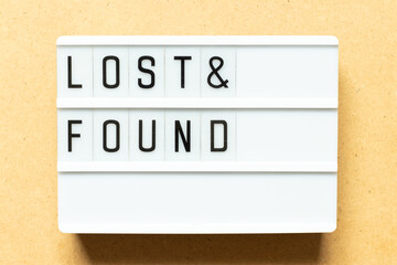 Lightbox with word lost & found on wood background