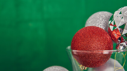 Red and silver Christmas balls and green space for Christmas.