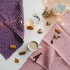 Coffee cup, cookies, cinnamon and napkins on white rustic wooden background. Breakfast concept. Top view, flat lay style