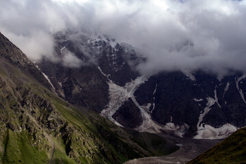 Mountain peaks with glaciers.
View of Mount Donguzorun from the slopes of Mount Cheget. Terskol, Caucasus, Russia.