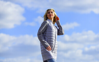 Windy day. Girl jacket cloudy sky background. Woman fashion model outdoors. Woman enjoying cool weather. Freshness of wind. Matching style and class with luxury and comfort. Beauty and fashion look