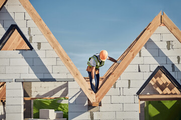 Cautious construction site worker working at height
