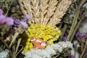 Bouquet of dried flowers close up. Spikelets of wheat and yellow flowers