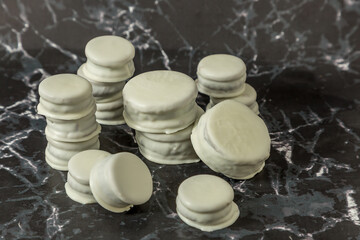 Homemade chocolate alfajores, typical of Argentina, marble background with copy space