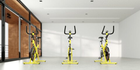 Three exercise bikes or spinning bikes at a distance