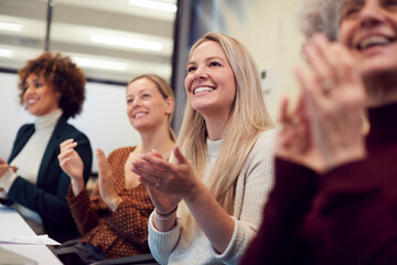 Line Of Businesswomen In Modern Office Applauding Presentation By Colleague