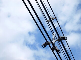 Fototapeta premium Cable Spacer with high voltage cables. Insulators that can add more power transmission lines and electricity immediately On the sky background there are white clouds with a copy space. Selective focus
