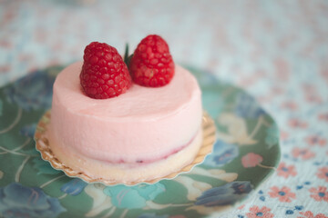 Blueberry mousse dessert on a dessert plate with fresh berries