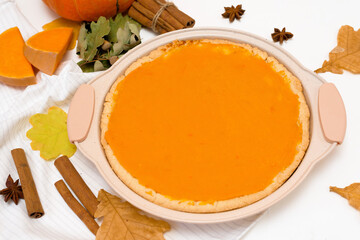 cooking homemade pumpkin pie with spices top view on a light background . autumn dessert of seasonal orange pumpkins