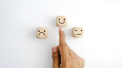 Hand choose smile cube, emotion on wood cube