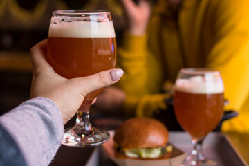 Boy and girl clink glasses of beer