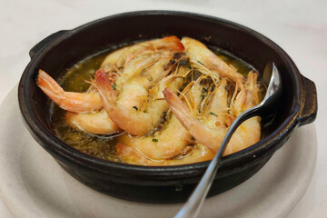 King prawns flambeed with brandy presented in a clay pot