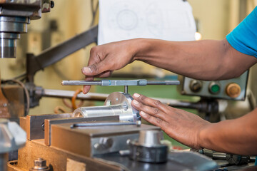 The tapping operation by skill worker. The thread making by hand tapping tool with