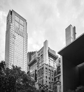 Black and white picture of New York City diverse architecture on a cloudy day, USA.