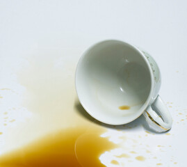 Spilled coffee cup on a white background.