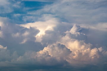 Naklejka na ściany i meble Beautiful stormy cumulus clouds in the sky, background.