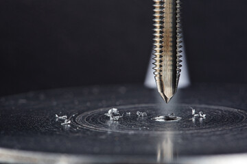 Obraz premium Thread tap. Tap drill steel billet. Working cutter.
