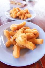Chinese bread stick or chinese donut on dish. Breakfast street food usually eat with hot tea, coffee or soy milk.