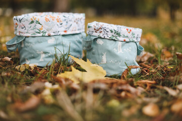 Empty cotton baskets or bags on the grass. close up view of autumn leaves on grass, fall time, autumn background