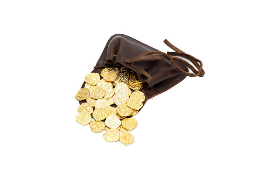 Leather old medieval pouch with poured gold coins isolated on white background.
