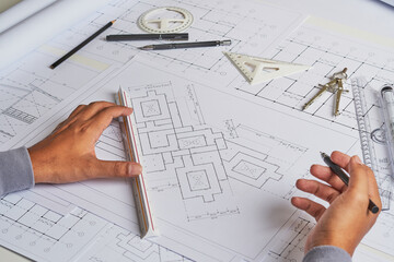 Architect engineer contractor design working drawing sketch plan blueprint and making architectural construction house building in architect studio.