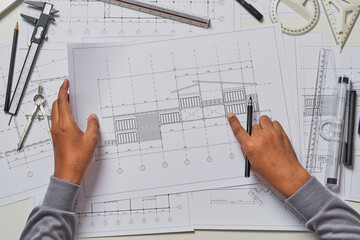 Architect engineer contractor design working drawing sketch plan blueprint and making architectural construction house building in architect studio.