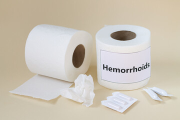 Hemorrhoids and constipation treatment concept. Toilet paper rolls and medical suppositories