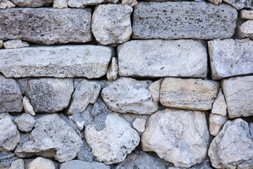 Stones in the wall of the house as an abstract background.