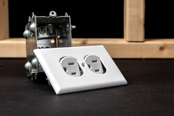 a standard North American 15 amp duplex outlet, outlet cover and a metal outlet box in a residential new construction environment